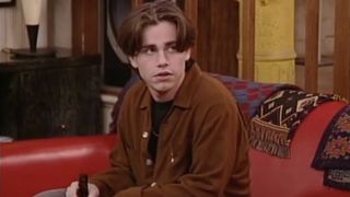 Rider Strong as Shawn with a bottle of beer on the couch in Boy Meets World.