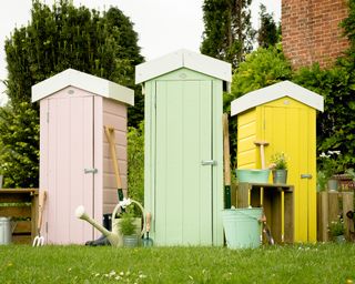 Trio of narrow sheds in light pink, mint, and vibrant yellow, for a cheerful garden update.