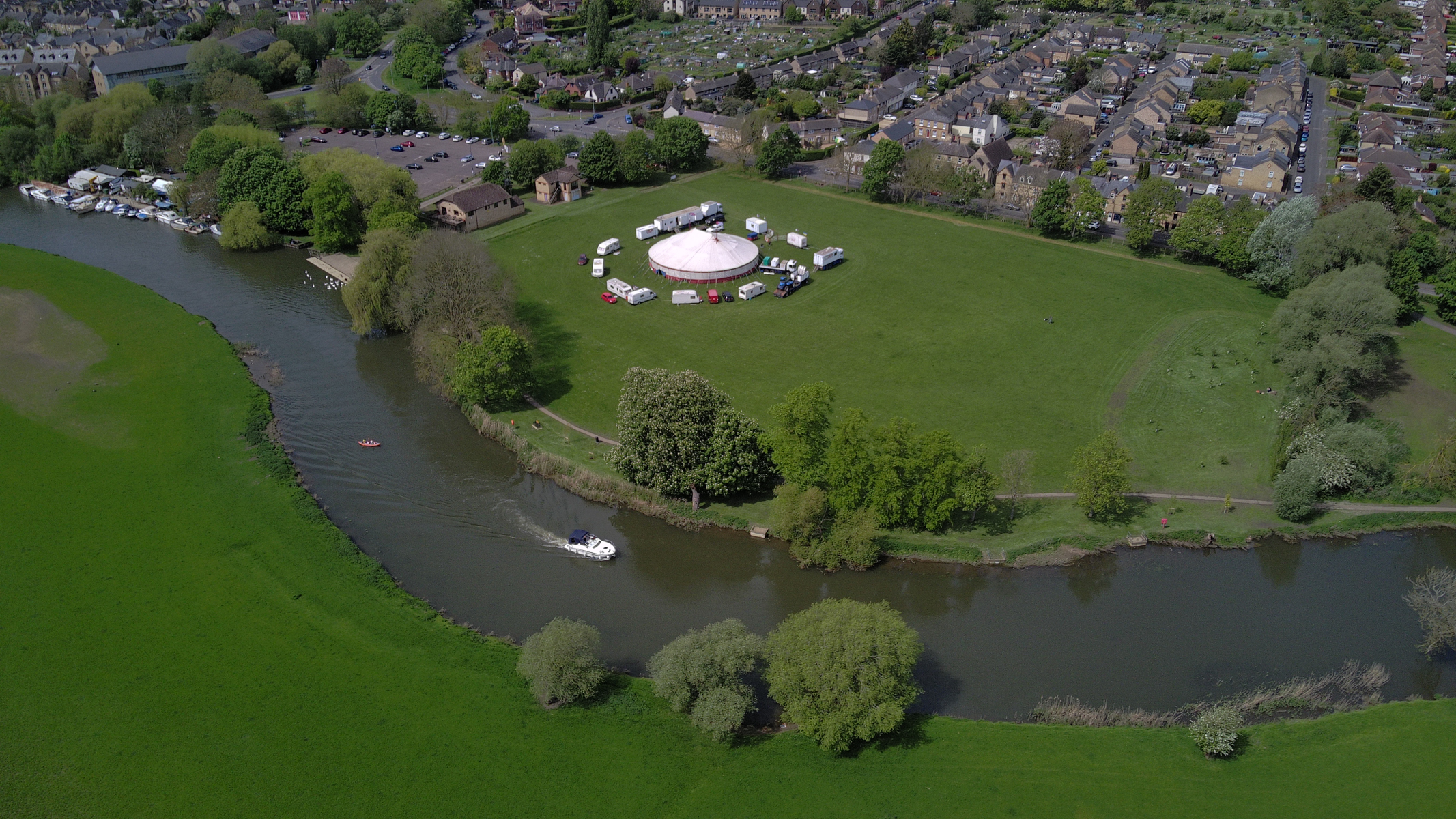 Photo of of a river with a field and circus in the background taken with the Holy Stone Sirius HS900