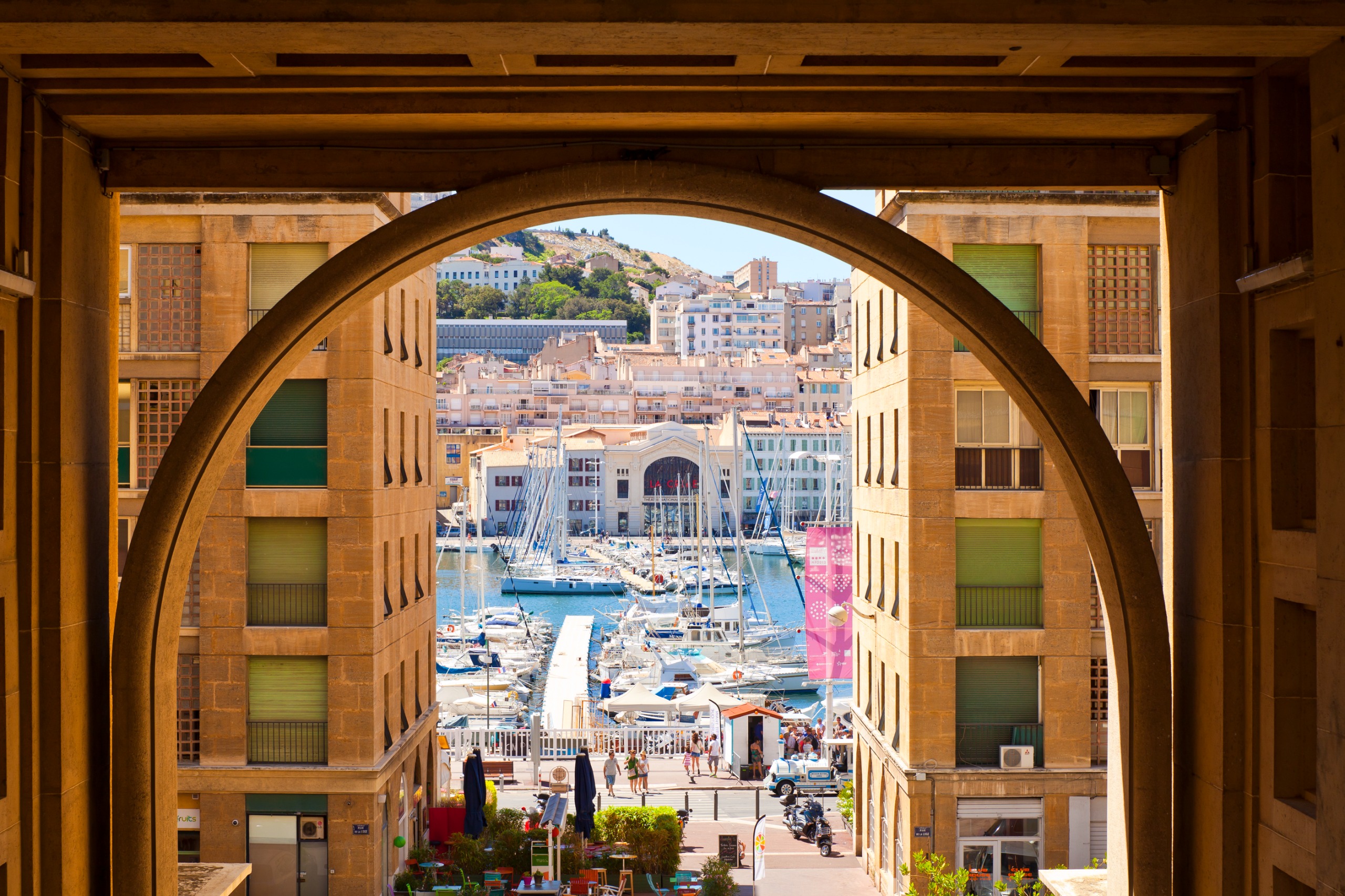 A view of Marseille through a large stone arch