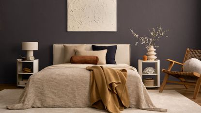 Bedroom with French Press Coffee walls, a large bed with neutral bedding, two white nightstands, a rattan lounge chair and a cream rug.