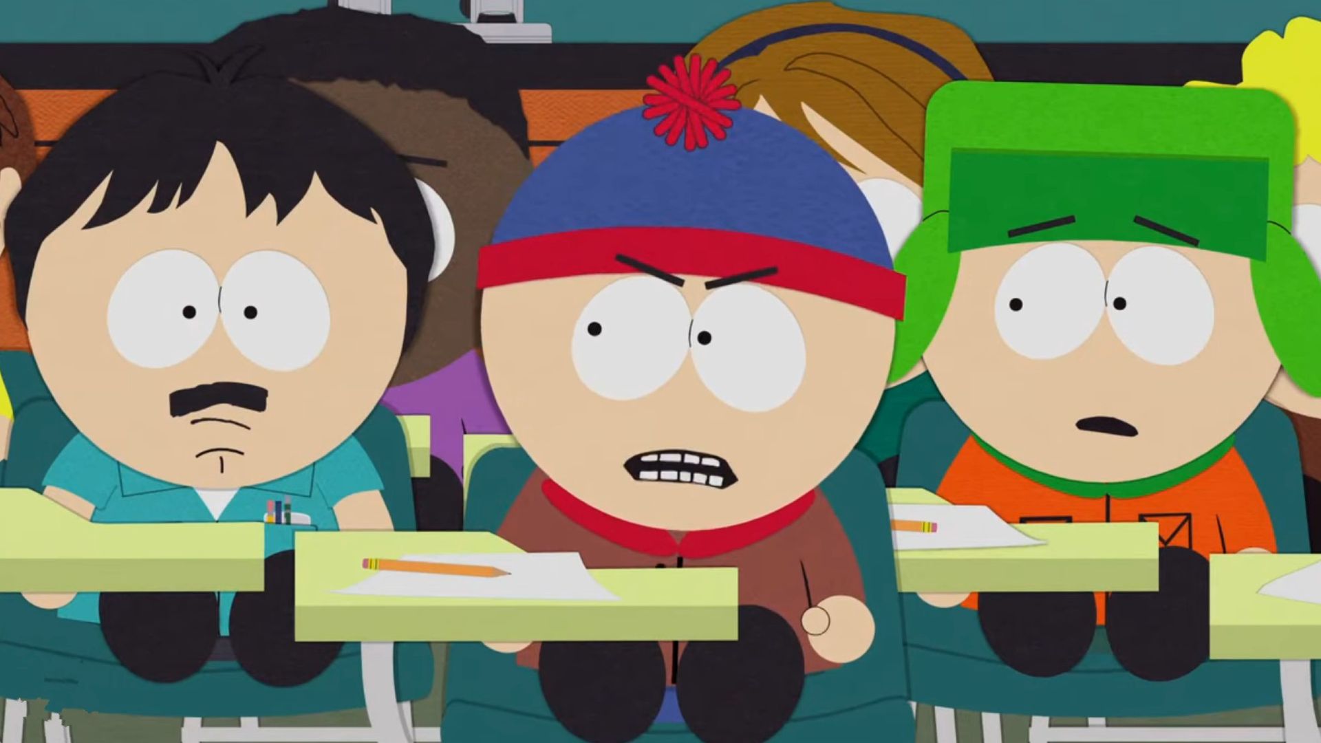 Randy sitting in class with Stan and Kyle. Kyle is very upset about it.