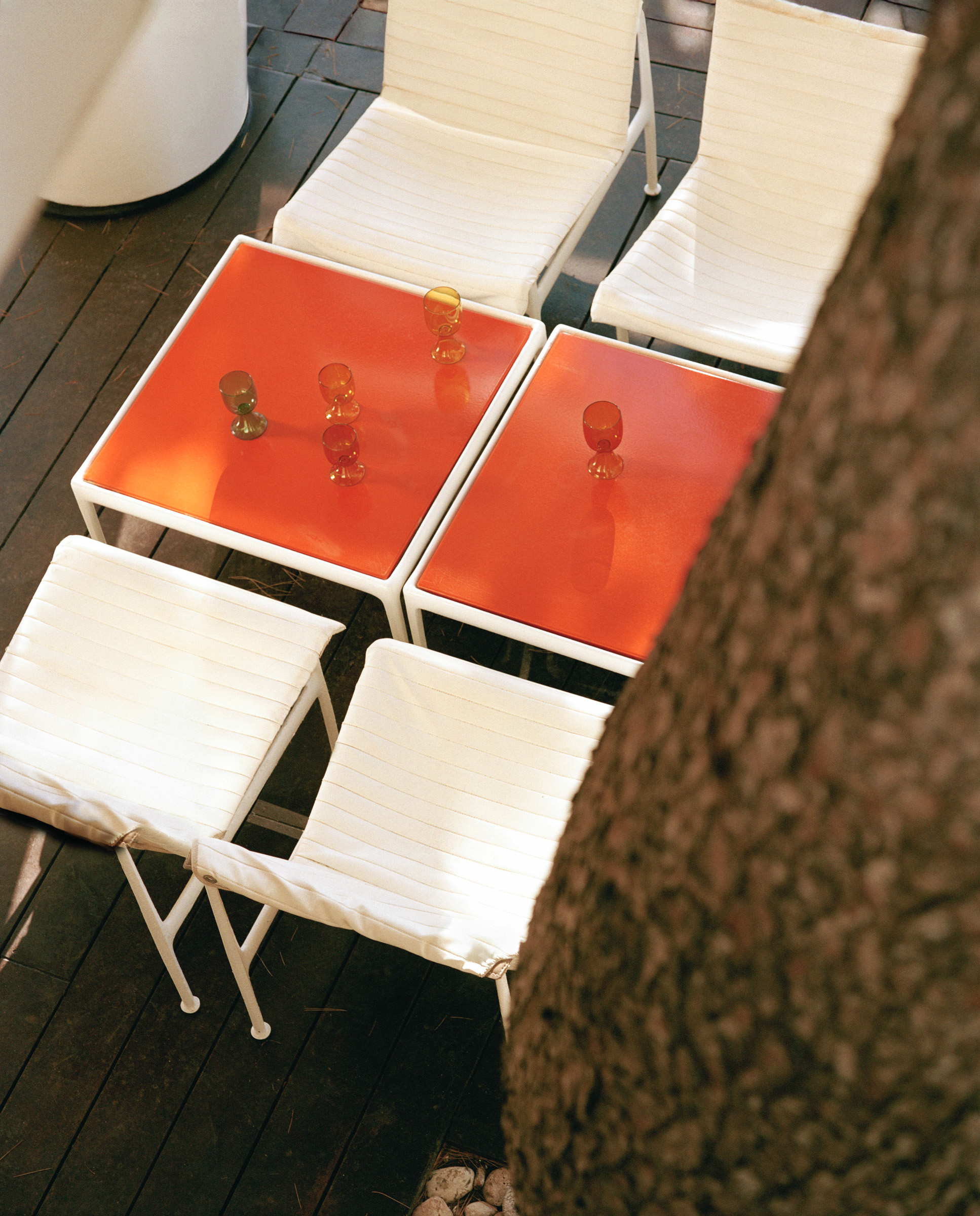 glassware on red tables with white chairs