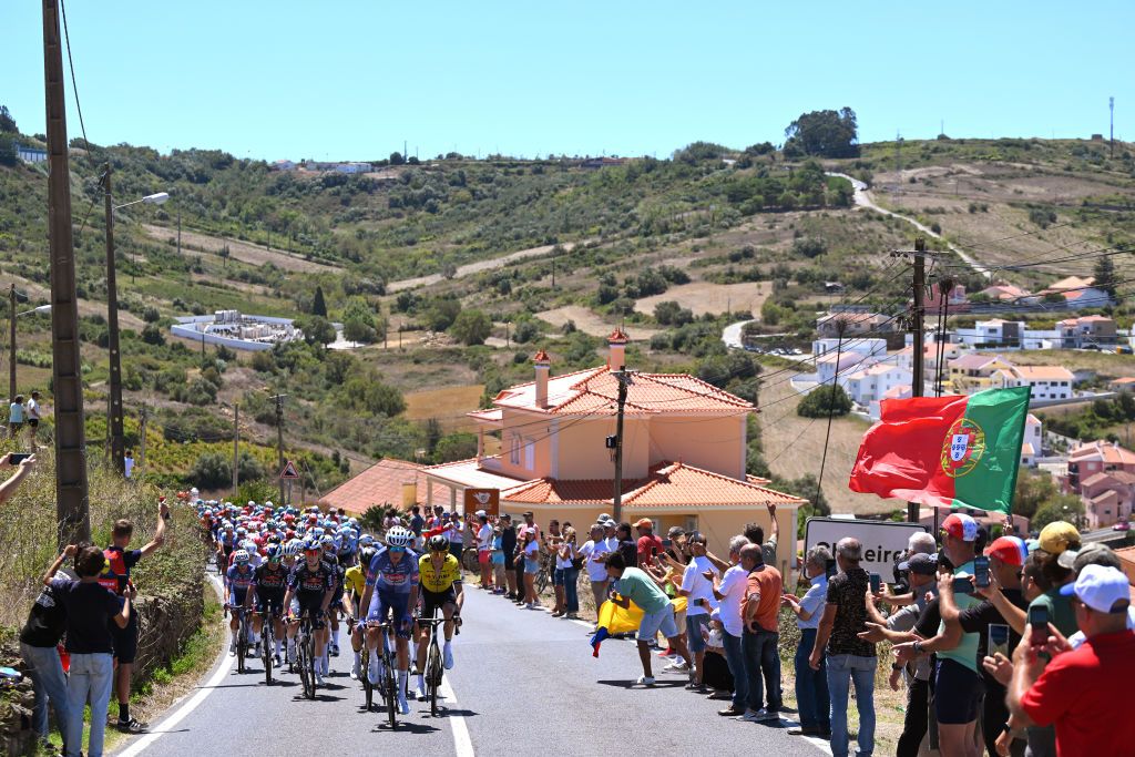 OUREM PORTUGAL AUGUST 18 Steven Kruijswijk of The Netherlands and Team Visma Lease a Bike Oscar Riesebeek of The Netherlands and Team Alpecin Deceuninck and Robert Gesink of The Netherlands and Team Visma Lease a Bike lead the peloton passing while fans cheer during the 79th La Vuelta Ciclista a Espana 2024 Stage 2 a 194km stage from Cascais to Ourem UCIWT on August 18 2024 in Ourem Portugal Photo by Tim de WaeleGetty Images
