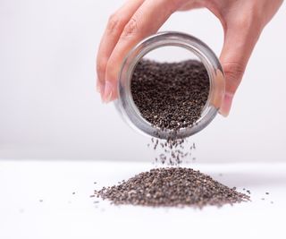 Chia seeds pouring from a jar