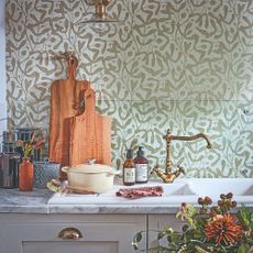 A kitchen with a wallpapered wall