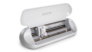 Cricut vs Silhouette; a craft cutting machine with an open lid