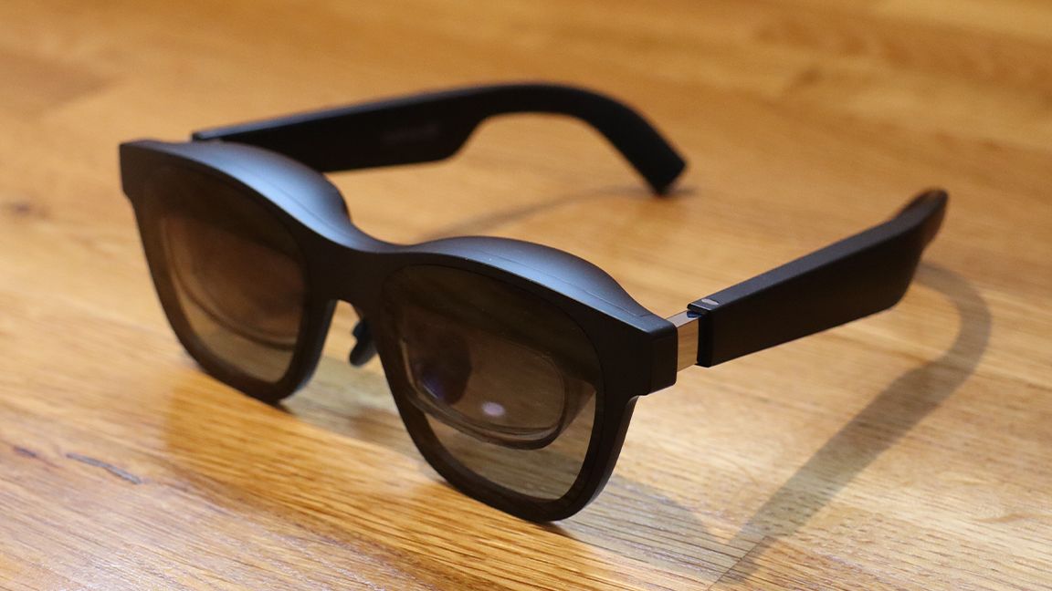 Nreal Air AR glasses; a pair of black AR glasses on a wooden table