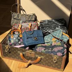 a louis vuitton trunk filled with vintage designer handbags