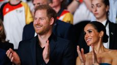 Prince Harry and his wife Meghan Markle clap and smile during the closing ceremony of the Invictus Games Düsseldorf 2023