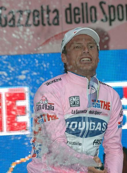 Di Luca has fun with the champers on the pink jersey podium