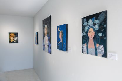 paintings displayed on a gallery wall