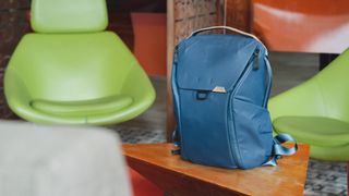 Peak Design Everyday Backpack 20L V2 in Midnight Blue on a table in a café outdoors