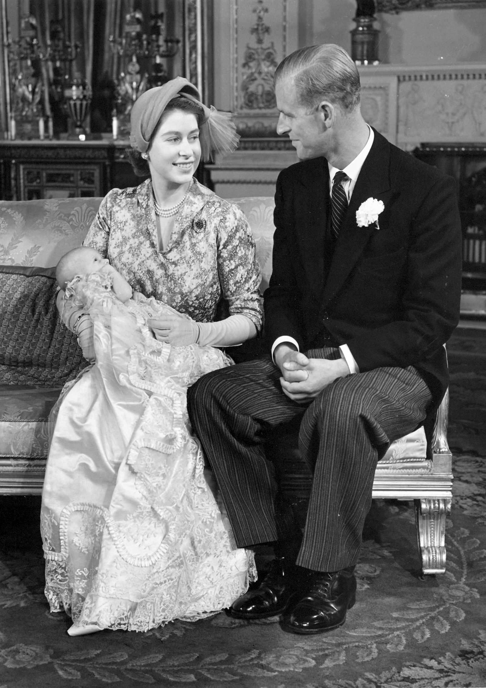 Queen Elizabeth and Prince Philip holding Princess Anne on her christening day