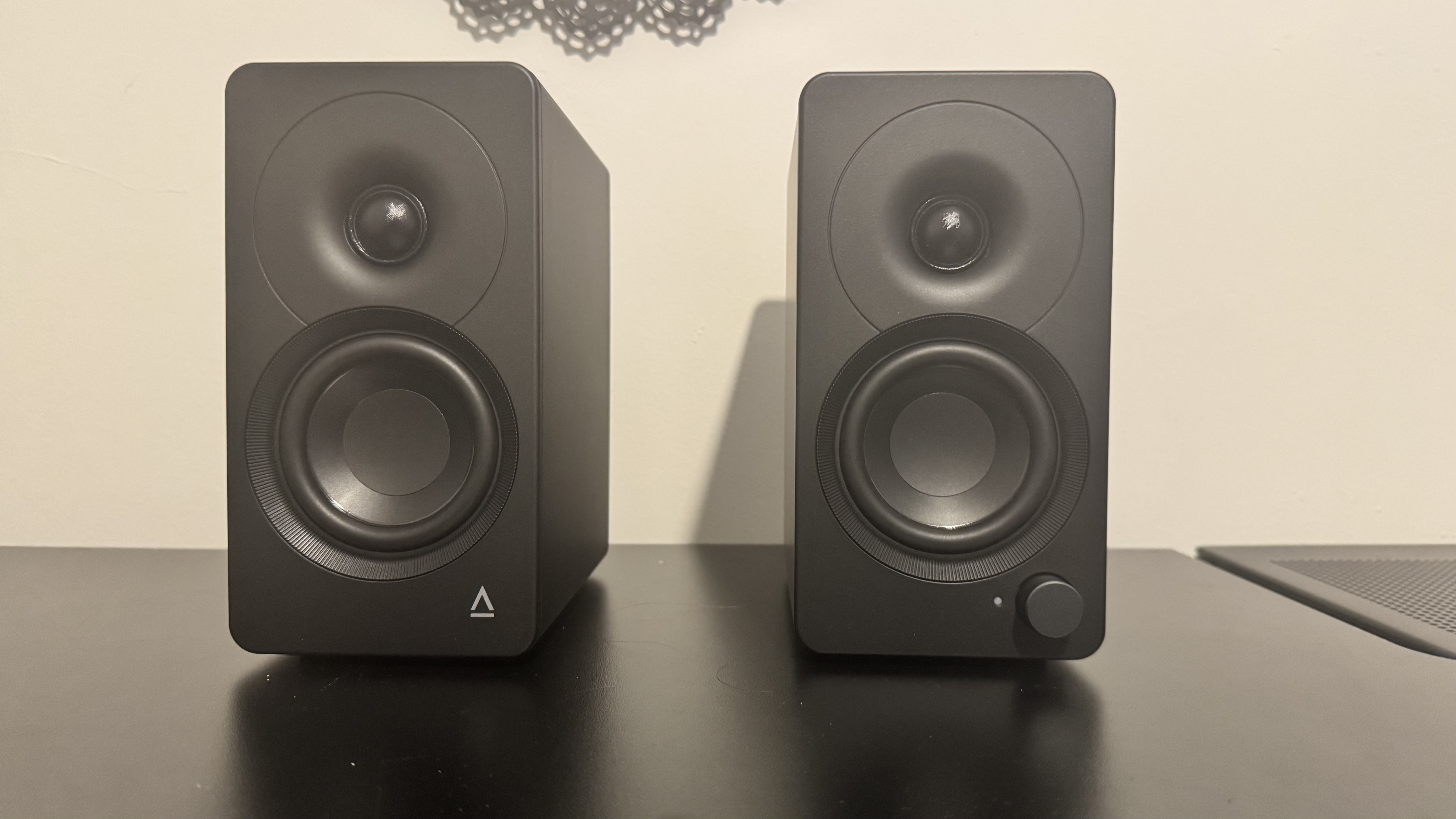 Creative XF1 speakers on a black desk