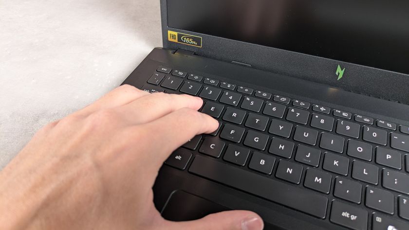 Fingers on keyboard of Acer Nitro V 15