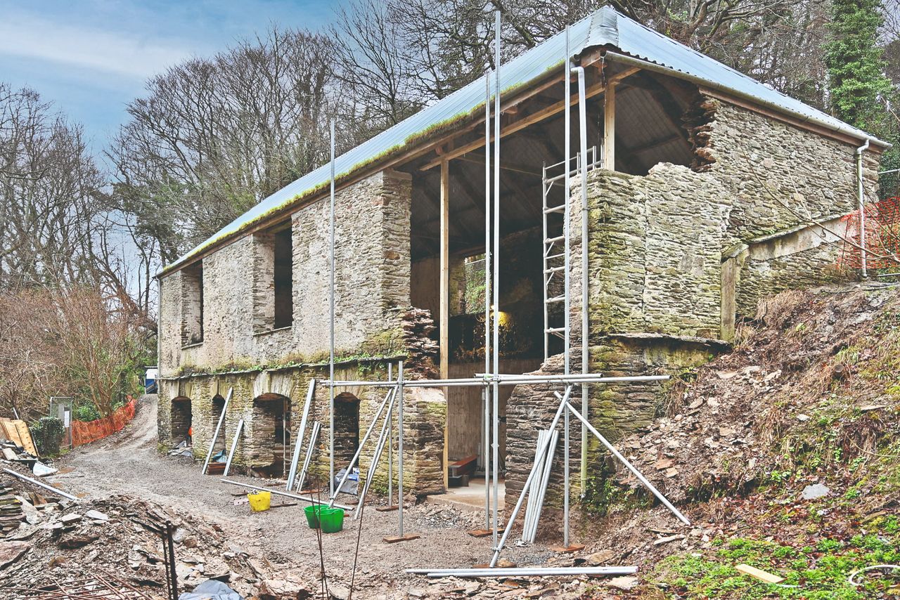 A barn under construction with scaffolding
