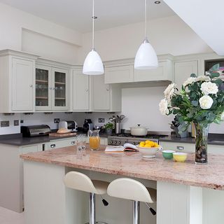 kitchen room with white kitchen cabinet flower vase