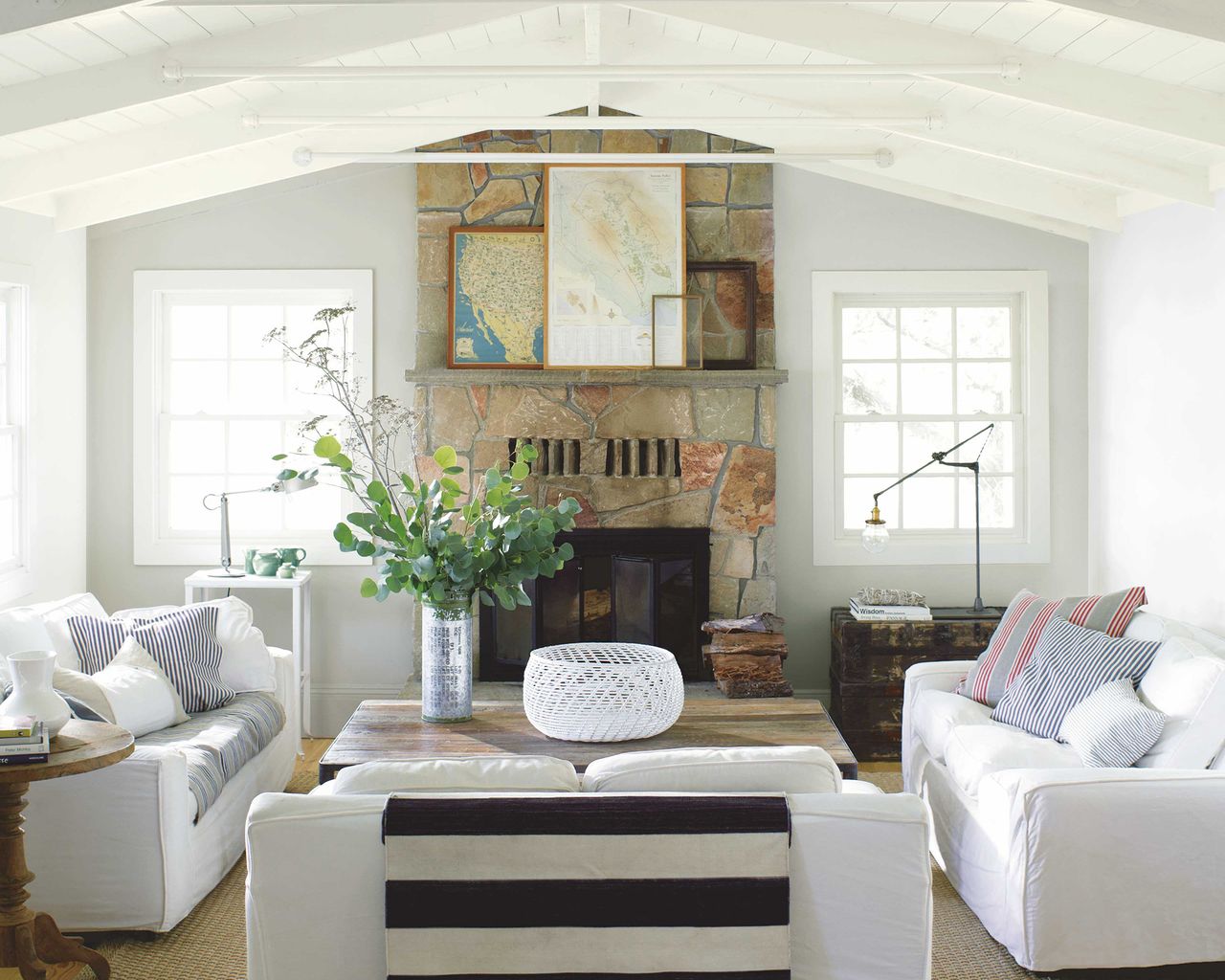 A classic living room with painted wooden beams and white upholstered sofa decor