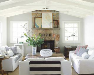 A classic living room with painted wooden beams and white upholstered sofa decor