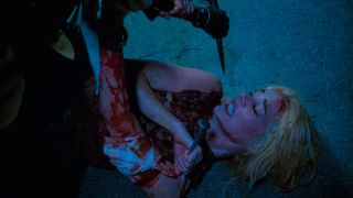 Ready Or Not 2 Here I Come Samara Weaving fighting on the ground with a stake in her shoulder