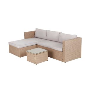 A rattan chaise corner sofa set in a natural colourway with cream cushions
