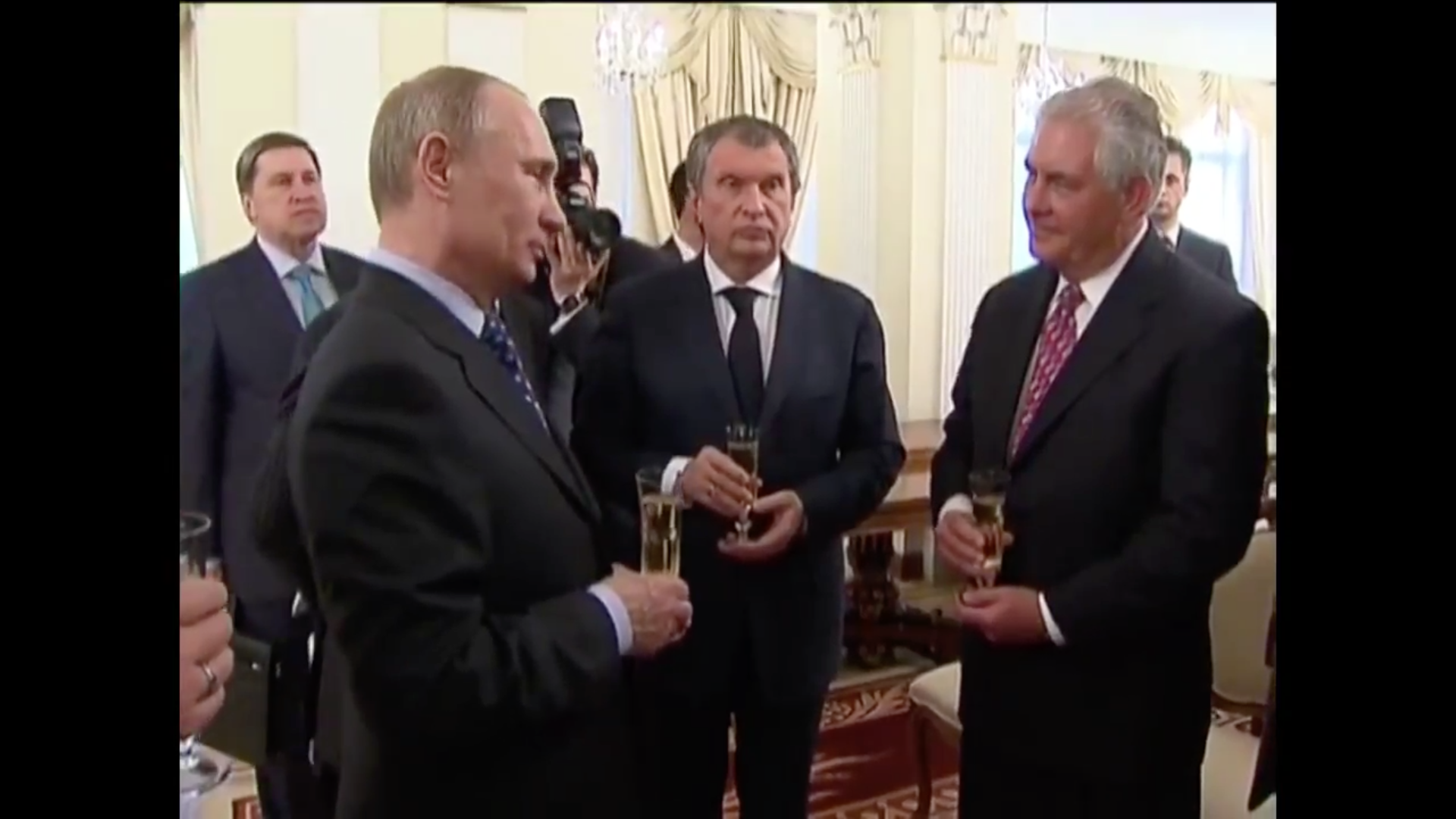 ExxonMobil CEO Rex Tillerson drinking champagne with Vladimir Putin.
