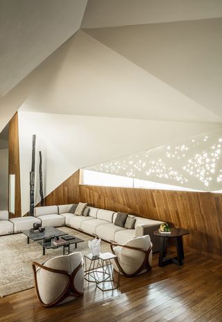 Living room with white sofa and wooden flooring