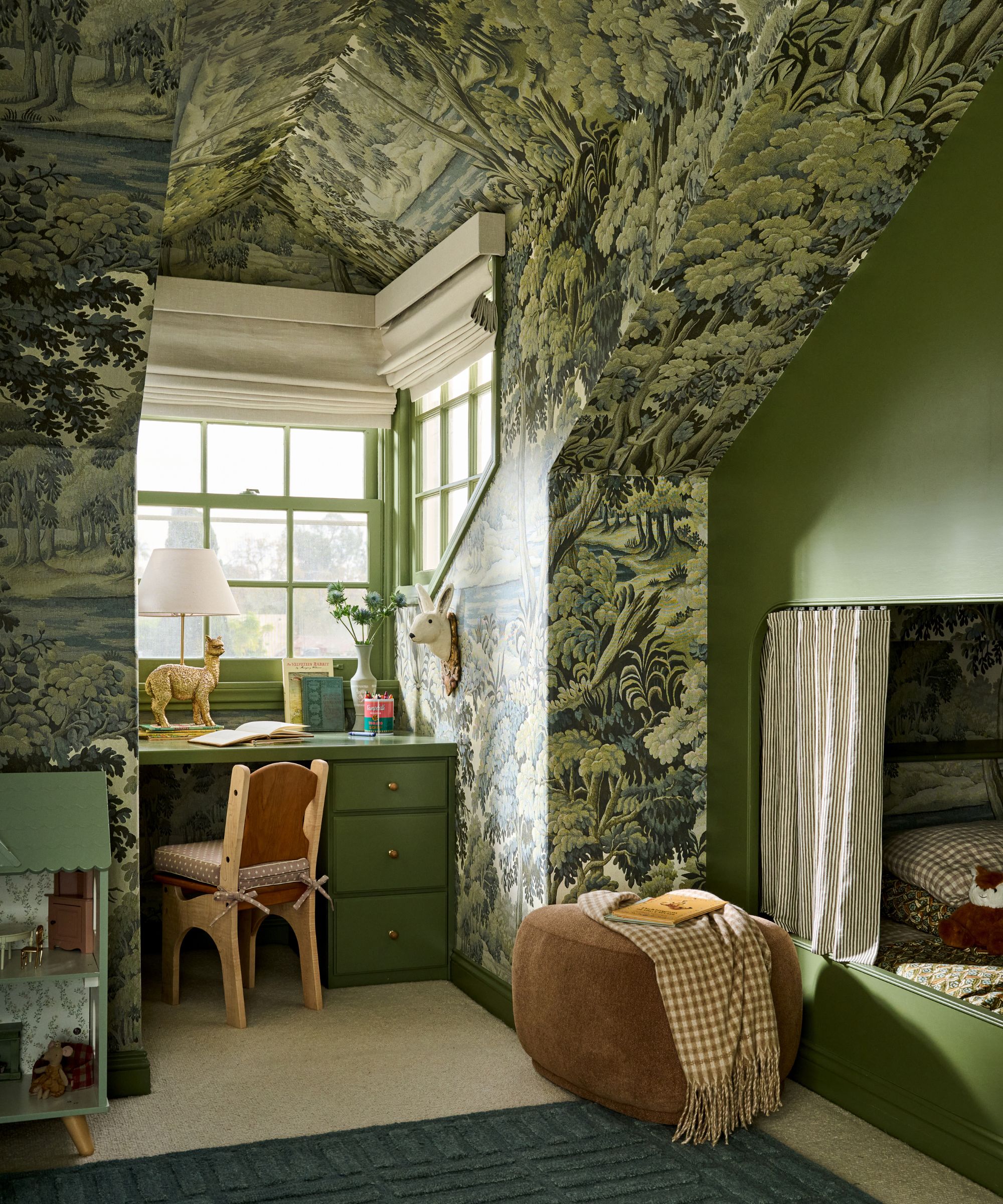 a botanical wallpapered kids attic room with custom green bunk beds and desk beneath a small window