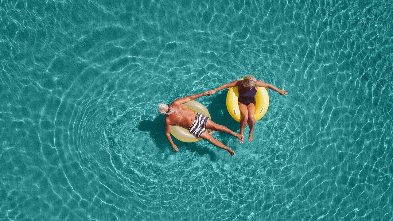 Happy retirees float on rafts in a pool.