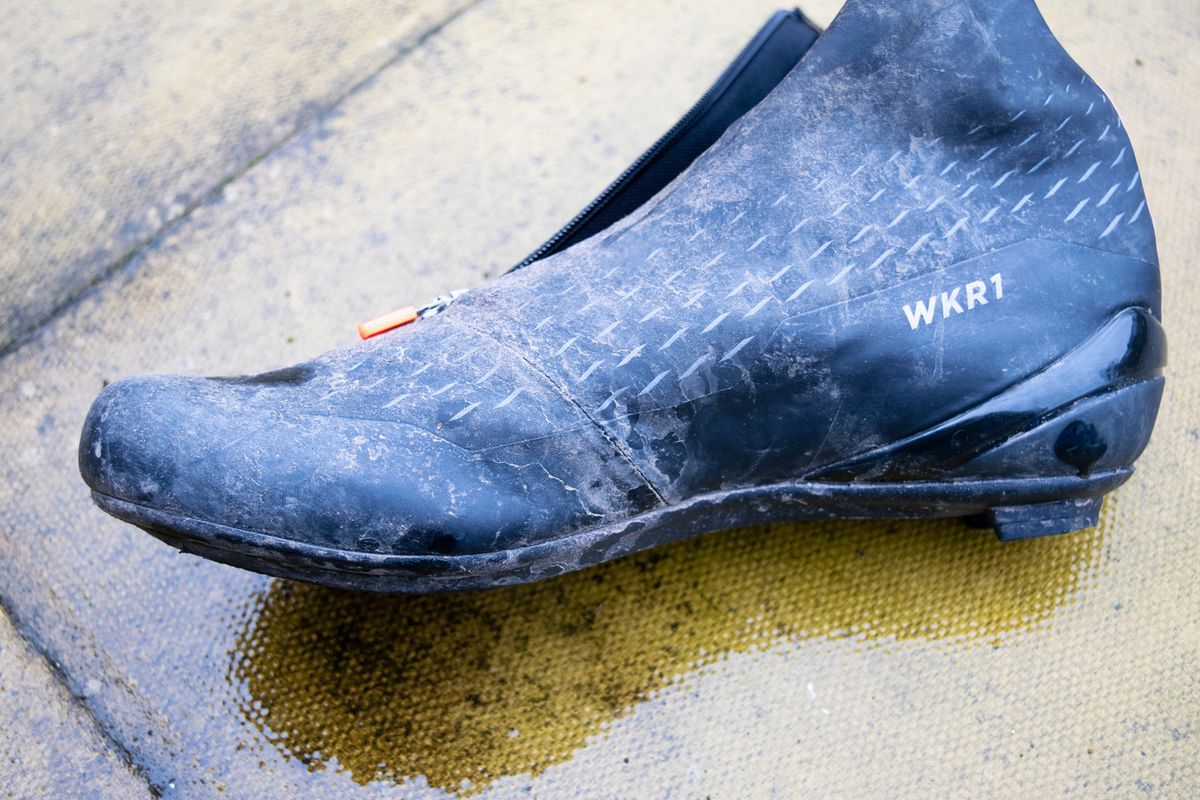 A dirty DMT WKR1 cycling shoe on a patio
