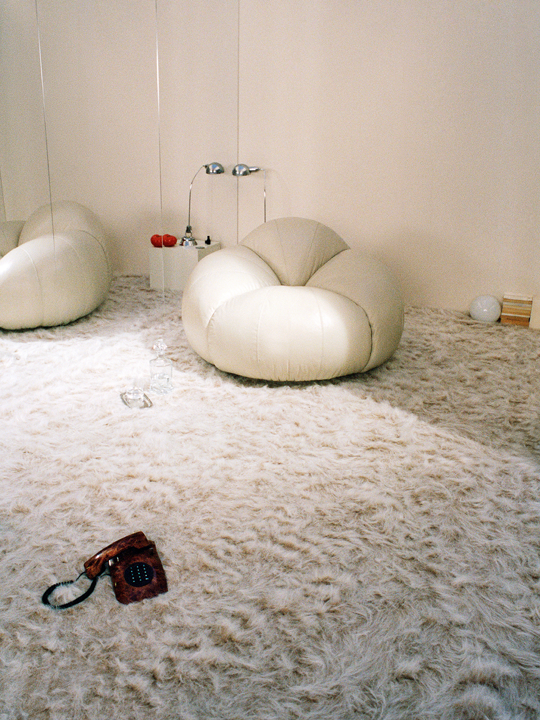 A white leather tomato shaped chair designed by Chlo&amp;eacute;.