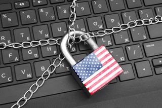 A chain and US flag padlock on a computer keyboard