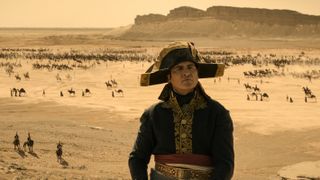 Joaquin Phoenix as Napoleon Bonaparte in the Egyptian desert in Napoleon. 