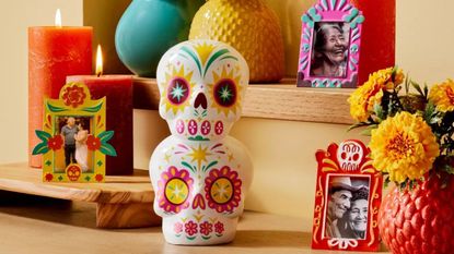 Some of Luis Pinto's Día de Muertos collection at Target - a stacked calavera sculpture and picture frames