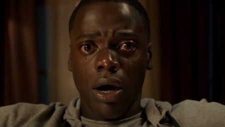 Daniel Kaluuya in Get Out with tears rolling down his face as he looks frightened.