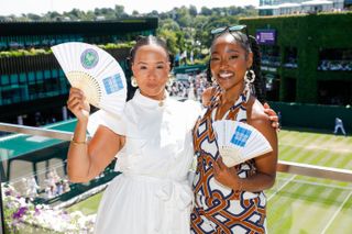 Golda Rosheuvel and Arsema Thomas at Wimbledon, fanning themselves from the heat