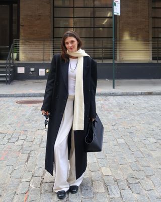 Fashion influencer @cocoschiffer wearing a chic long wool winter coat.