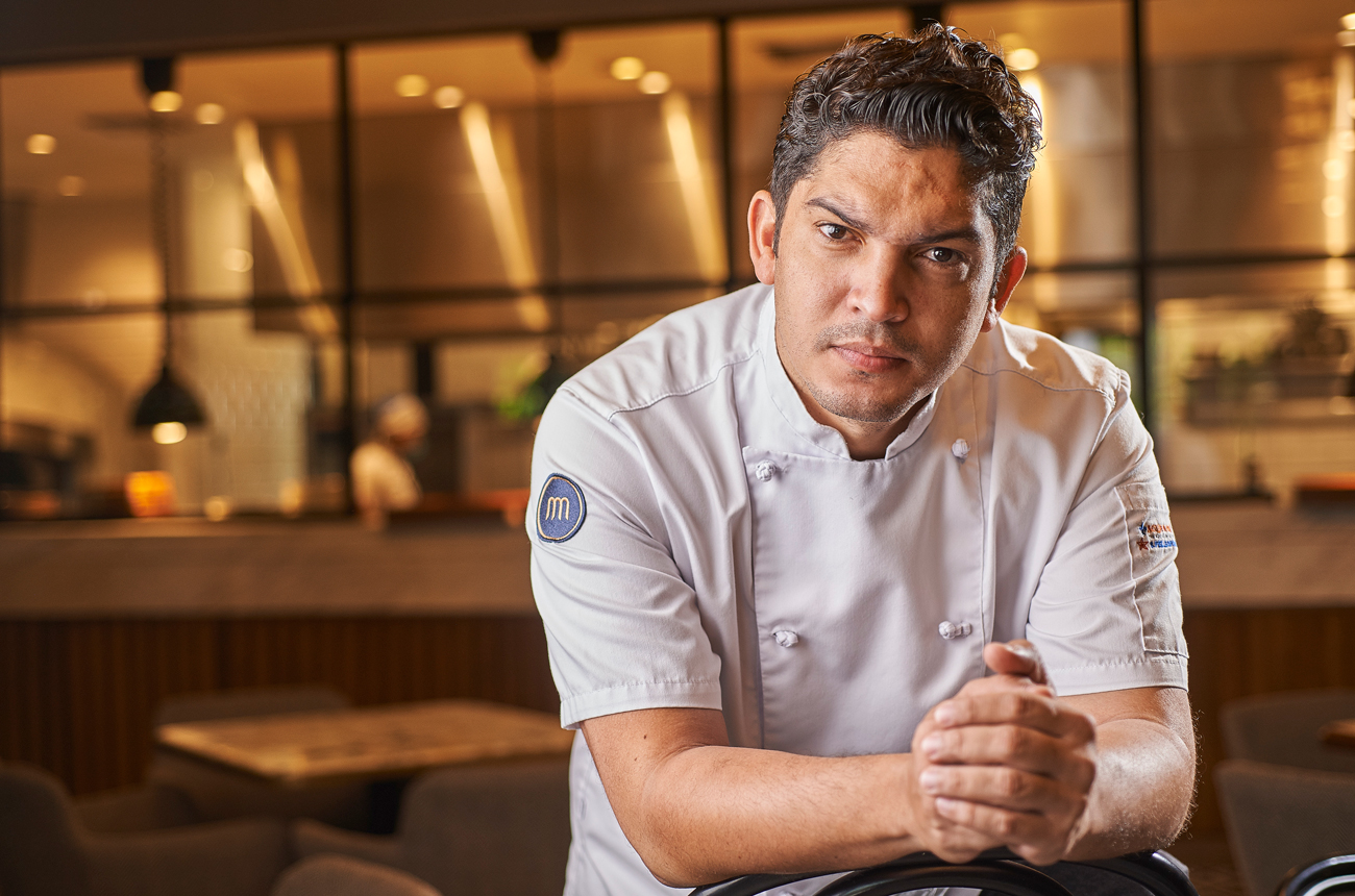 A chef in a restaurant looking directly at the camera