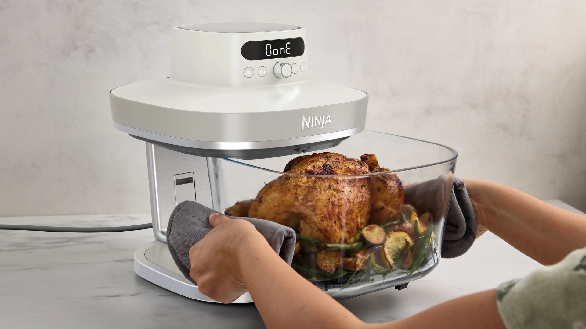 Ninja Crispi Pro air fryer in a white and blue kitchen