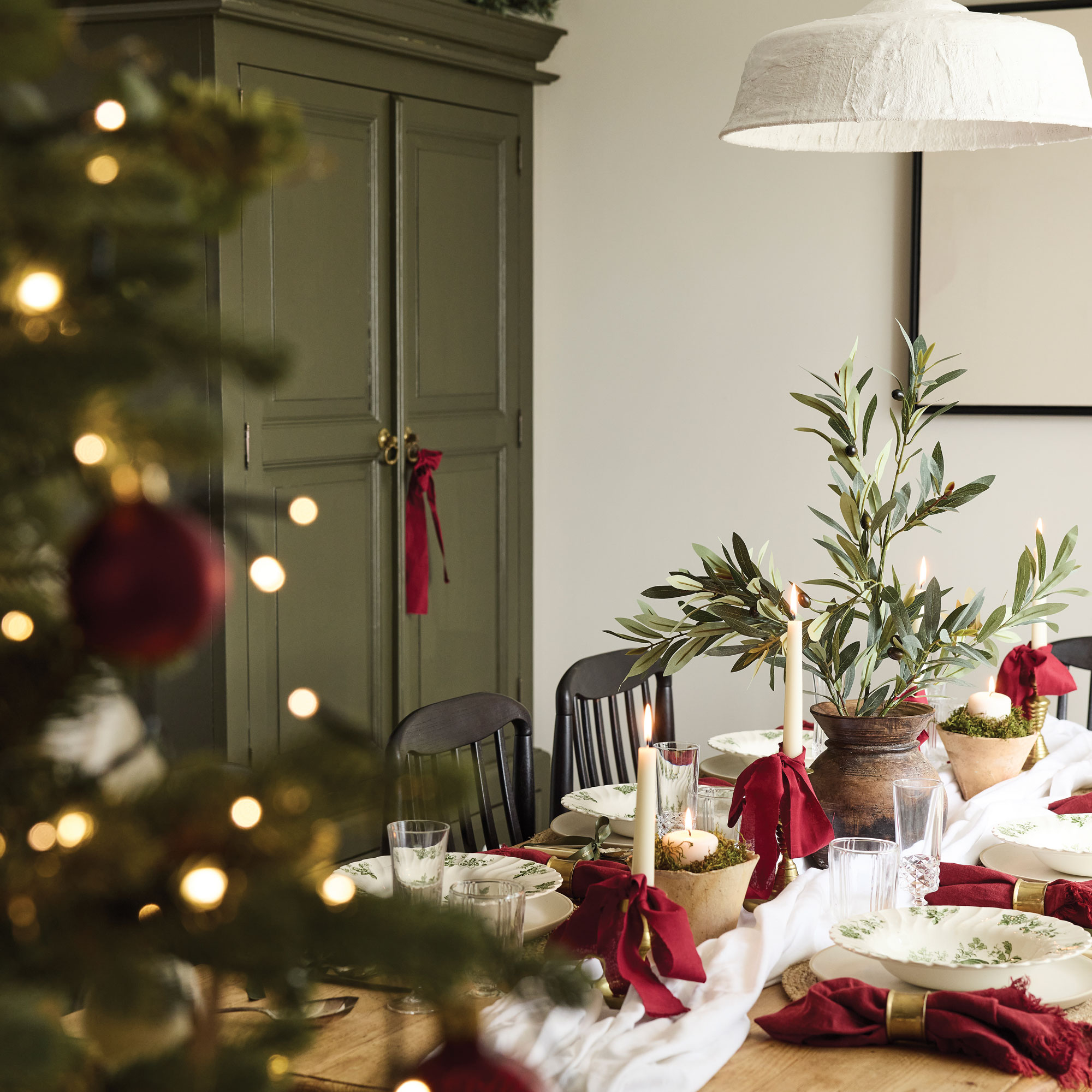 Dining table decorated with red bows for Christmas