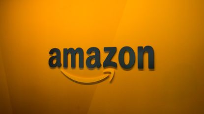 Amazon logo and branding pictured on an orange-colored wall at the company's corporate headquarters in Seattle, Washington State.