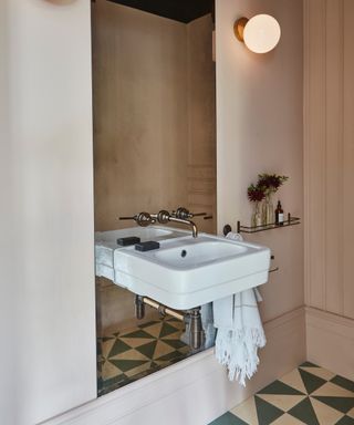 narrow bathroom ideas, small bathroom with large mirror, small sink, patterned tiled floor, blush walls