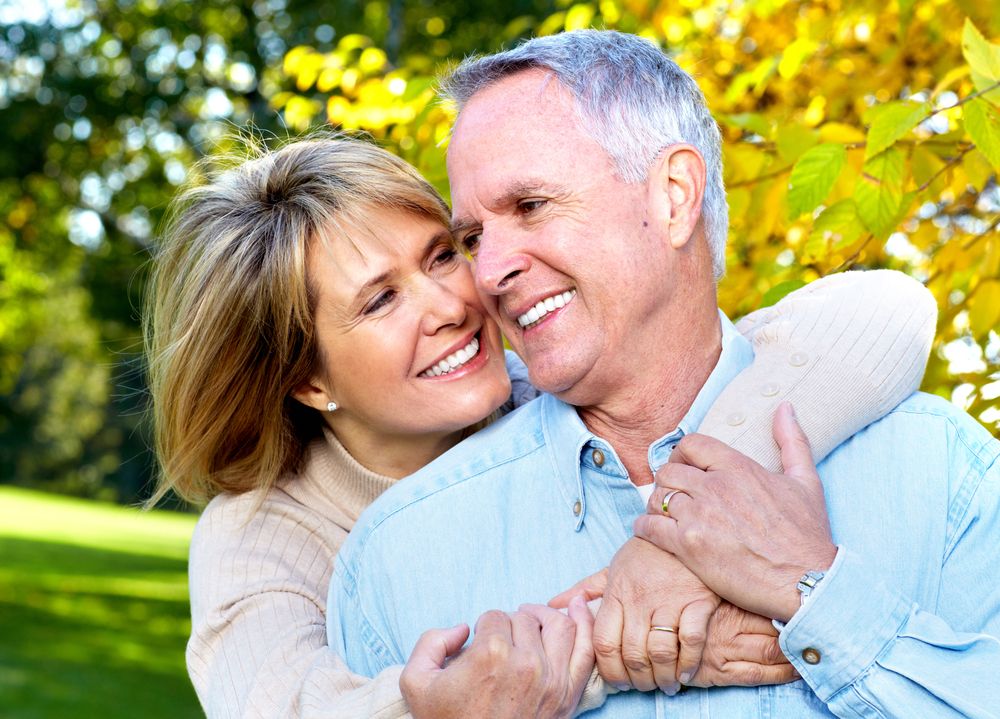 A happy older couple embraces