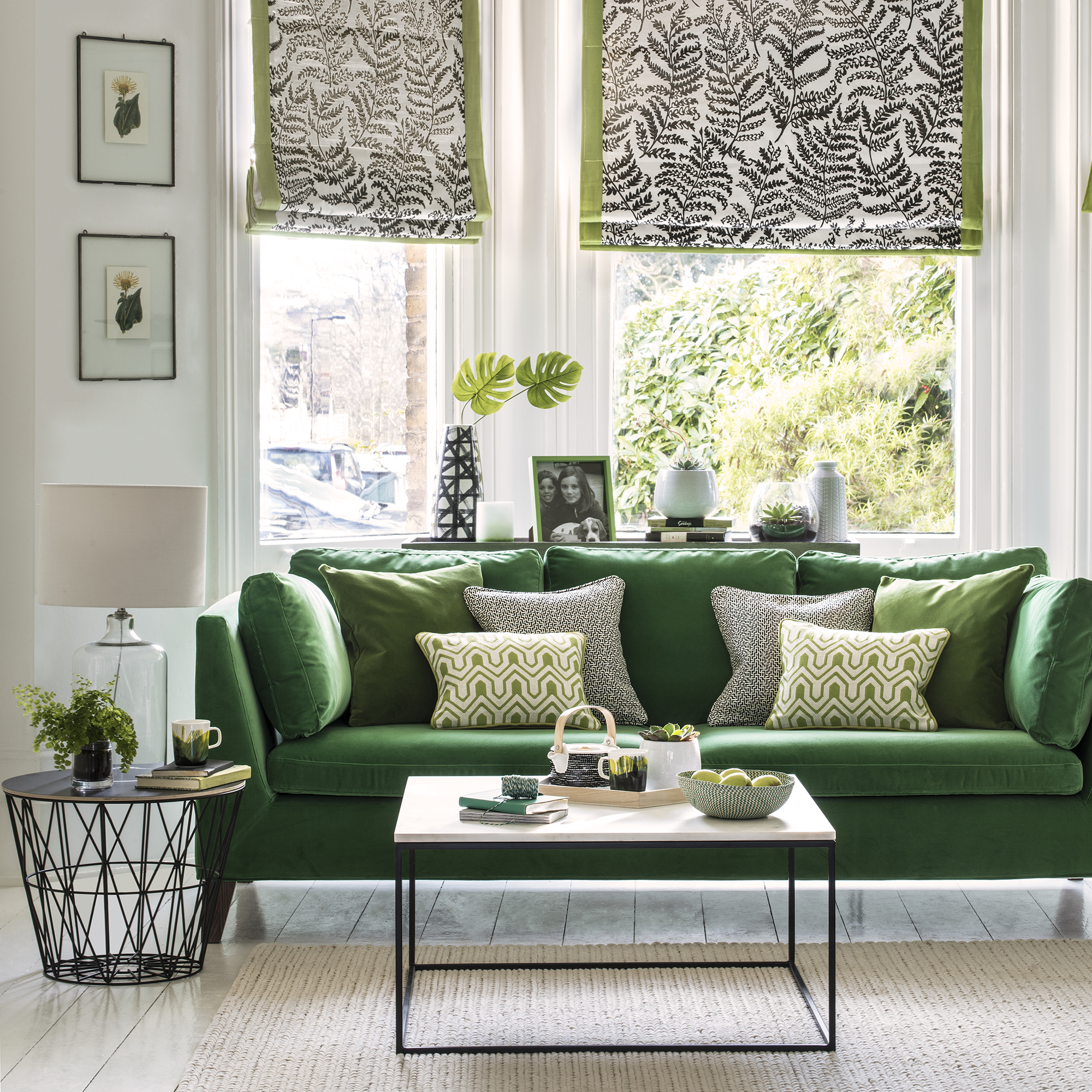 living room with green sofa and patterned cushions