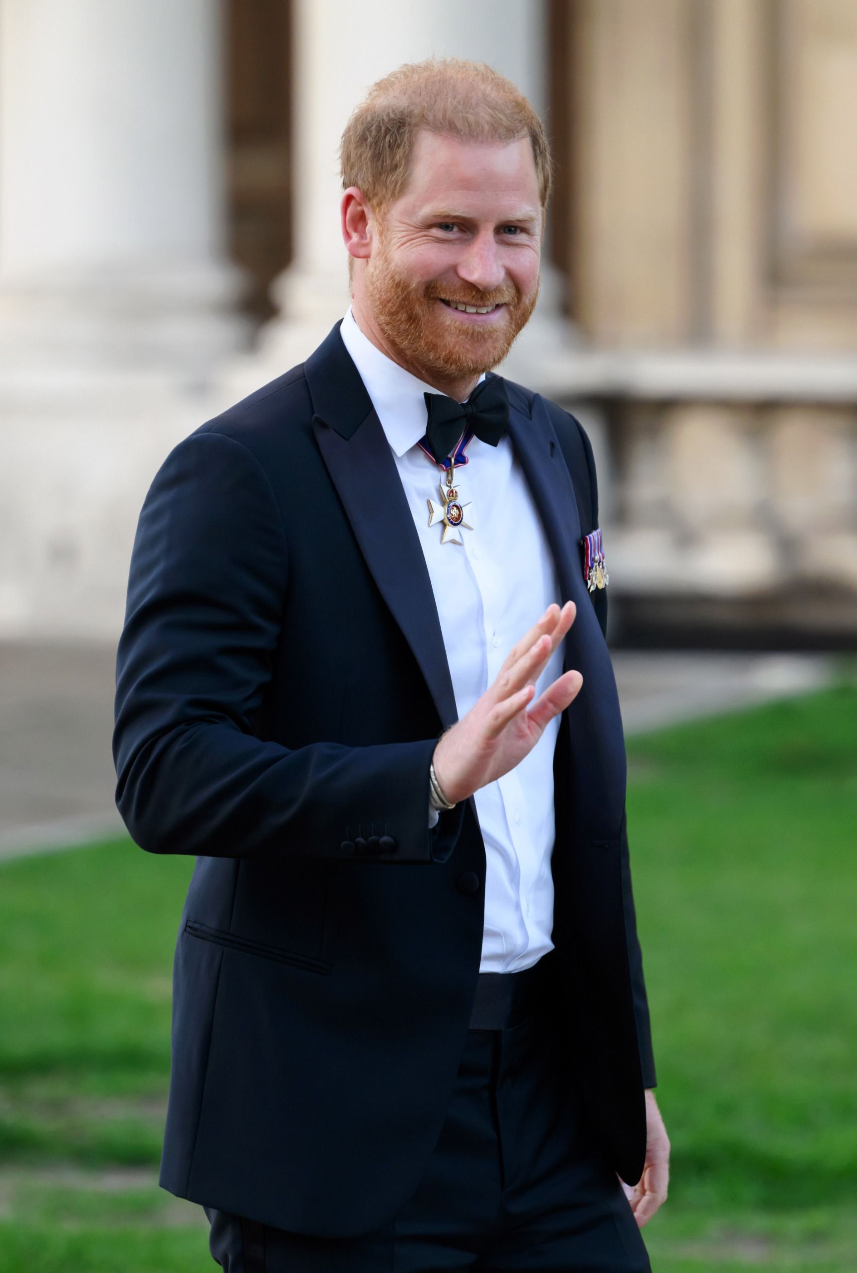 Prince Harry wearing a tux and waving