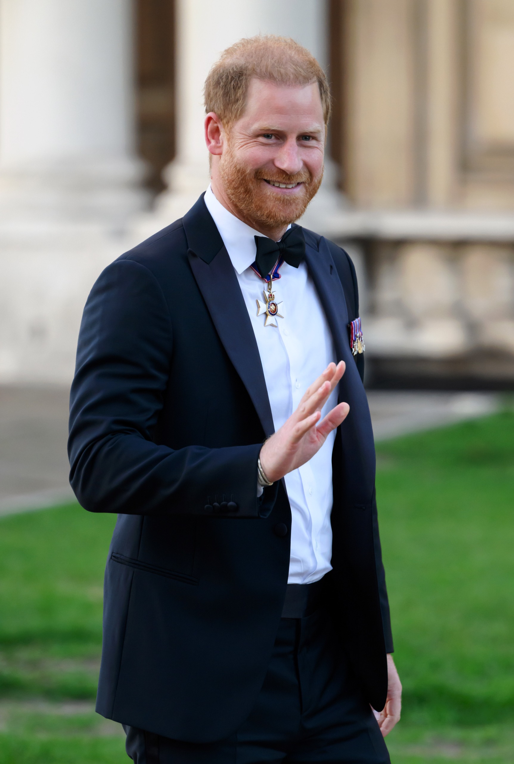 Prince Harry wearing a tux and waving