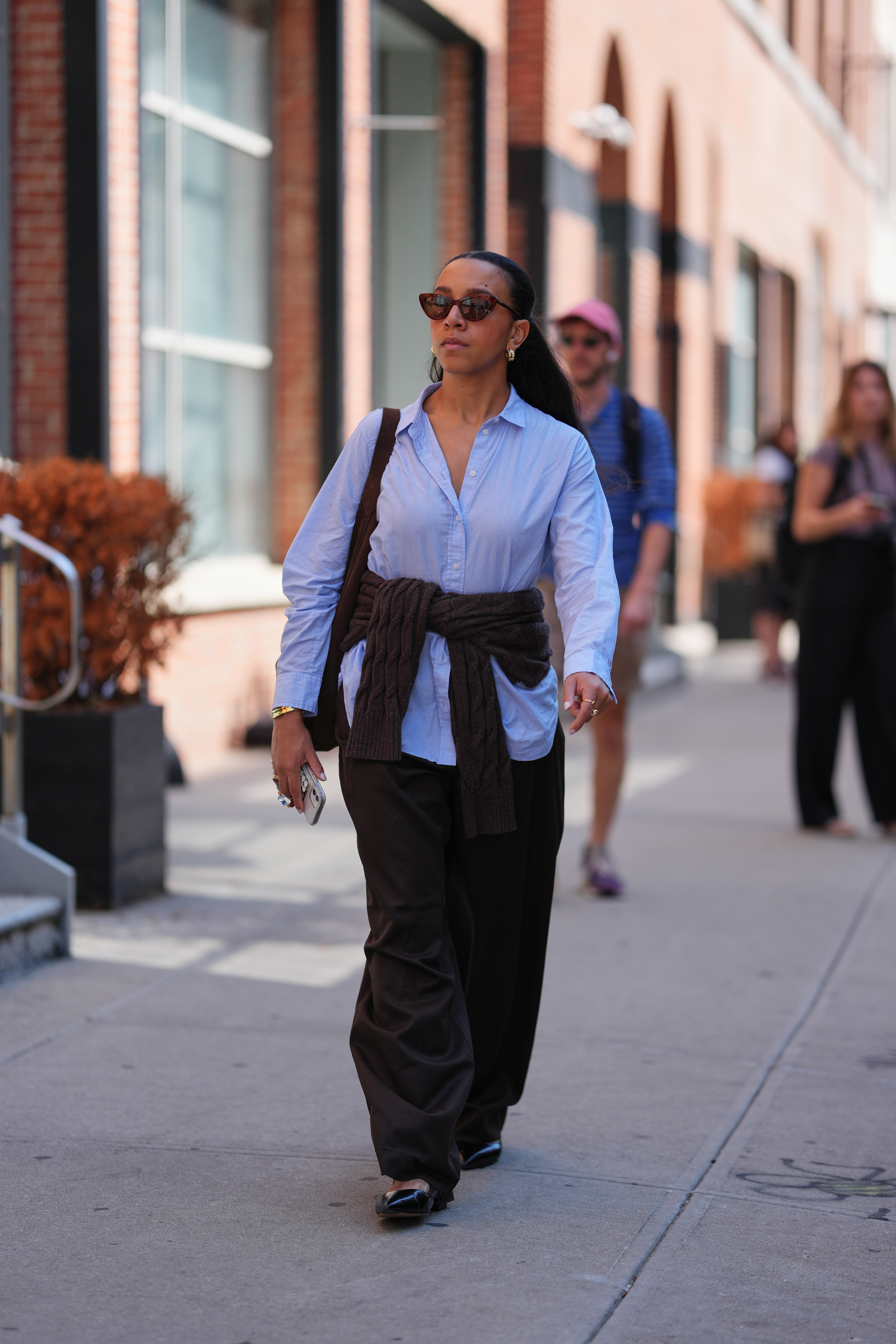 Woman in light blue shirt and brown pants