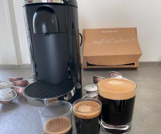 Nespresso Vertuo Plus with coffee in front