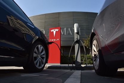 Tesla cars charge up.